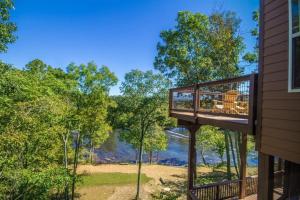 a deck with a view from a house at Eagle's Nest- A pet friendly cabin on the river! in Oak Hill