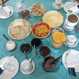a table topped with different types of food and desserts at Casa Urutí in Colonia Valdense