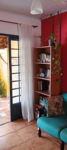 a living room with a couch and a book shelf at Casa da Flor in Morretes