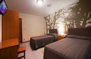 A bed or beds in a room at Hostal Restaurante Terra Chá