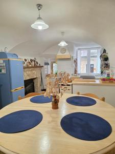 a kitchen with a wooden table with blue plates on it at La Casa del Castello in Alvito
