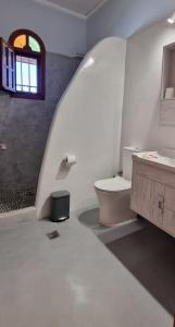 un bagno con un water, un lavandino e una finestra di Orchid 3 Bedroom Suite Kastraki a Kastraki