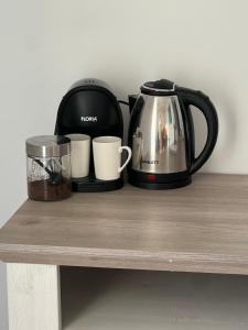 two coffee pots and a toaster on a table at LaLa HOME in Oradea