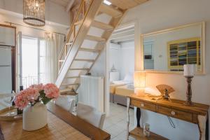 a living room with a staircase and a bedroom at Selene Seaside Apartment in Lygia +25 photos