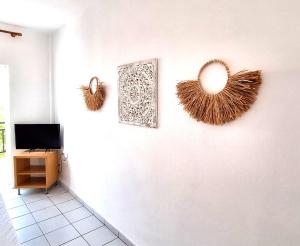 a room with two mirrors on a wall with a tv at Villa Thalassa Apartments in Pefkochori