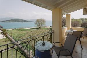 a balcony with a table and a view of the water at Selene Seaside Apartment in Lygia
