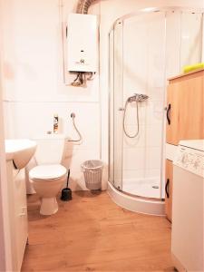 a bathroom with a shower and a toilet and a sink at Pokoje - Gdynia Śródmieście in Gdynia