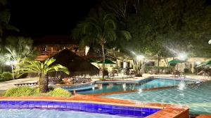 a large swimming pool at night with lights at Solar de Pipa Prime - Frente piscina in Pipa