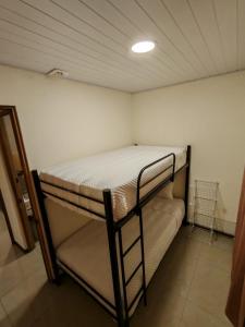a bedroom with a bunk bed in a room at Bandera Beach Cabins in Parrita