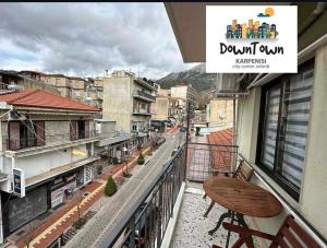 a balcony with a table and a view of a city at Down Town Karpenhsi in Karpenisi