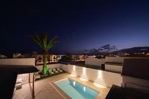 a swimming pool on the roof of a building at night at VillaSue in Tías