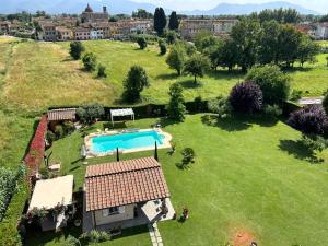 an aerial view of a yard with a swimming pool at Rustico del Chiasso - Villa With Private pool near Lucca in Lucca