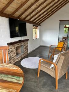 a living room with a couch and a fireplace at Belo Nascer 2 in Joanópolis