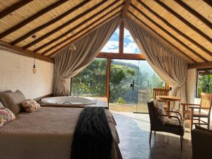 a bedroom with a bed and a tub in a room at Belo Nascer 2 in Joanópolis