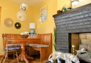 a living room with a table and a fireplace at The Flower Pot in Lexington