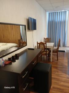 a bedroom with a bed and a desk with a mirror at Eni Rooms in Ohrid