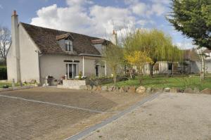 a house with a brick driveway in front of it at Les rouches in Cormeray