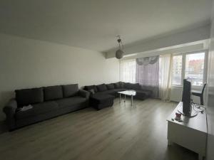a living room with a couch and a tv at Kivimiehenkatu 4 in Kouvola +3 photos