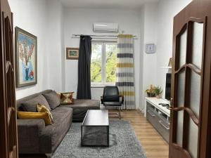 a living room with a couch and a chair at Kelly's Cozy Hideaway - Central Tirana in Tirana
