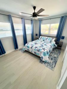 a bedroom with a bed and a ceiling fan at The Blue River House in Fort Myers