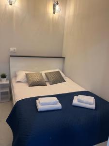 a bedroom with a bed with two towels on it at Apartamenty Sienkiewicza 41 in Kielce