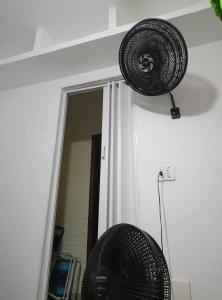 a room with a mirror and a fan on the wall at apartment 1 bedroom in Mongaguá
