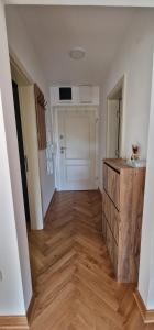 Vrnjačka BanjaにあるApartman Veraのウッドフロアの廊下が備わる空間
