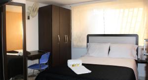 a bedroom with a bed and a desk and a chair at Casa Jac in Bucaramanga +121 photos