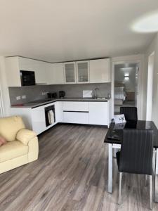 a kitchen and living room with a table and a couch at Ledgowan Bunkhouse in Achnasheen