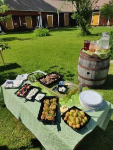 a picnic table with food and a barrel of wine at Reittiö B&B in Sulkava