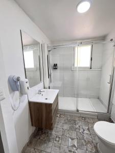 a white bathroom with a shower and a sink at BB Casita Blue Hotel in Santiago +173 photos