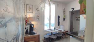 a kitchen with a table and chairs in a room at PARIS AUTHENTIC HOUSE Métro Line 14 Station Hôpital Bicêtre, RER B Gentilly in Paris