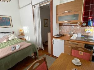 a small room with a bed and a kitchen at room 10 m from the sea in Opatija