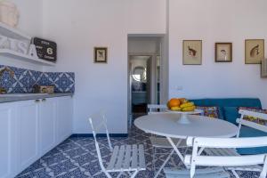a kitchen and living room with a table and chairs at Zisa Top Romantic Terrace & Private outdoor Jacuzzi in Palermo