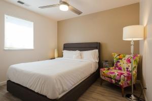 a bedroom with a bed and a lamp and a chair at The Sonoma Grape Escape 4 BD and 2,5BA Wineries Nearby in Sonoma
