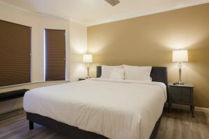 a bedroom with a large white bed and two lamps at The Sonoma Grape Escape 4 BD and 2,5BA Wineries Nearby in Sonoma +30 photos