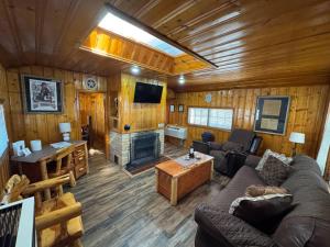 a living room with a couch and a fireplace at Cowboy's Trail with HotTub, King&QueenBed, in UpperCanyon, Pets welcome in Ruidoso