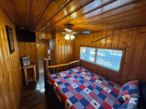 a bedroom with a bed in a wooden room at Cowboy's Trail with HotTub, King&QueenBed, in UpperCanyon, Pets welcome in Ruidoso