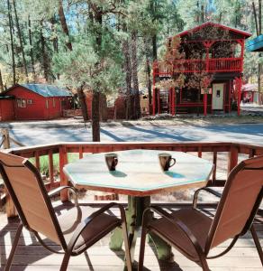 a table and two chairs on a patio at Cowboy's Trail with HotTub, King&QueenBed, in UpperCanyon, Pets welcome in Ruidoso