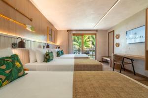 a hotel room with two beds and a desk at Resort Tororomba in Olivença +66 photos