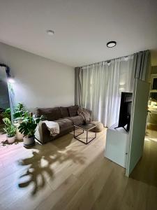a living room with a couch and a tv at Downtown studio by the sea in Reykjavík