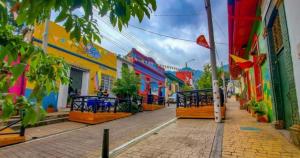 a street in a city with colorful buildings at Bogotá Urban Suites in Bogotá