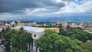 a large white building in a city with trees at Beautiful and central apartment in Tarija