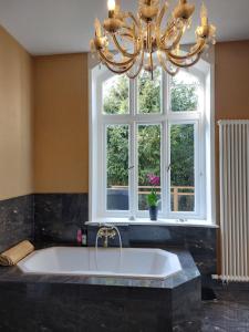 a large bath tub in a bathroom with a window at Villa Elisabeth 1905 in Bad Harzburg +58 photos