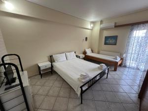 a bedroom with a bed and a couch in it at Mariangela Apartments in Lixouri