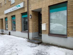 a store front with snow in front of it at Salon Harlekiini in Lieksa