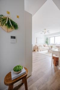 a white living room with a bowl of greens on a table at Beautiful NYC Skyline Aparthotel for 6 in New York