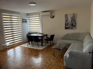 a living room with a couch and a table at Magdalena in Vranješ
