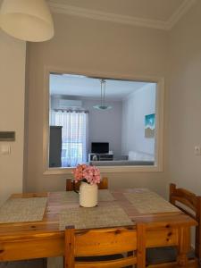 a dining room with a table and a large mirror at Rosie Apartment in Preveza