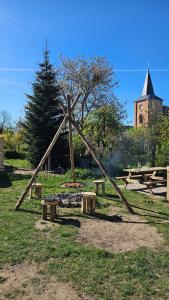 a group of picnic tables and benches in a park at Domek letniskowy Dolice in Dolice